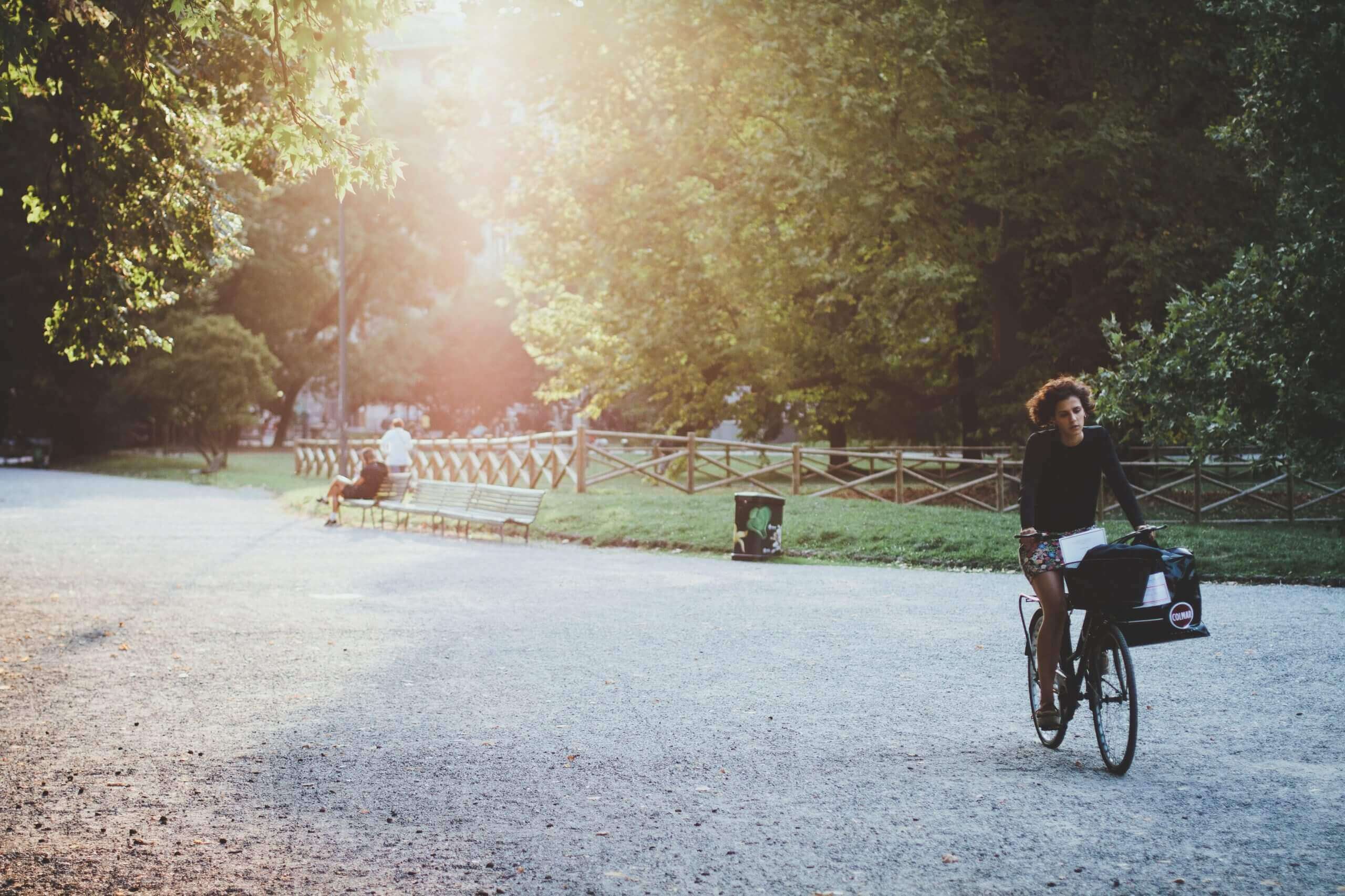 Photo by Fritz Bielmeier woman riding bicycle on park during daytime